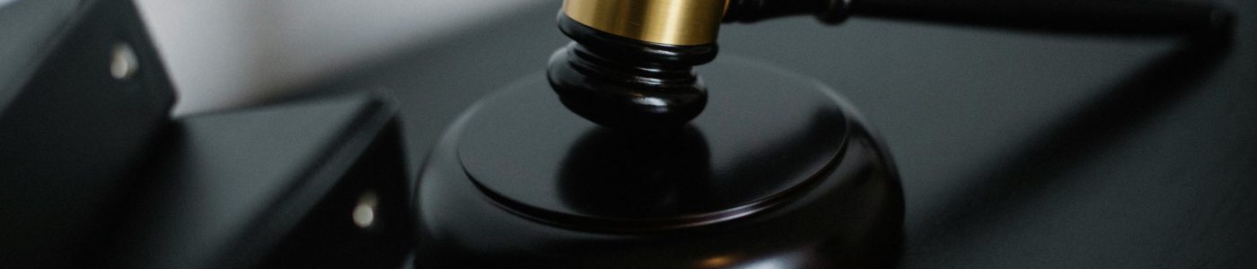 Close-up of a wooden gavel on a desk, symbolizing justice and legal authority.